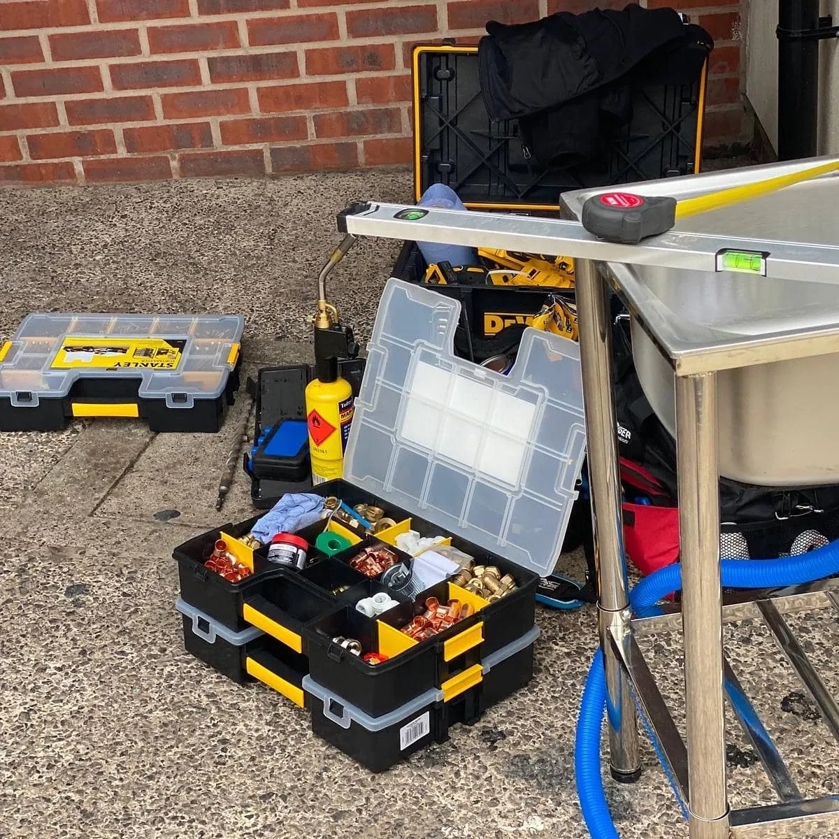 A table with a toolbox and tools on it.