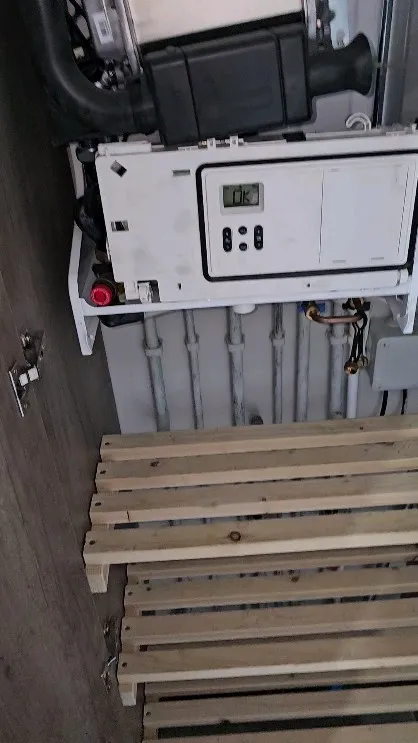 A wooden bench sitting next to a machine.