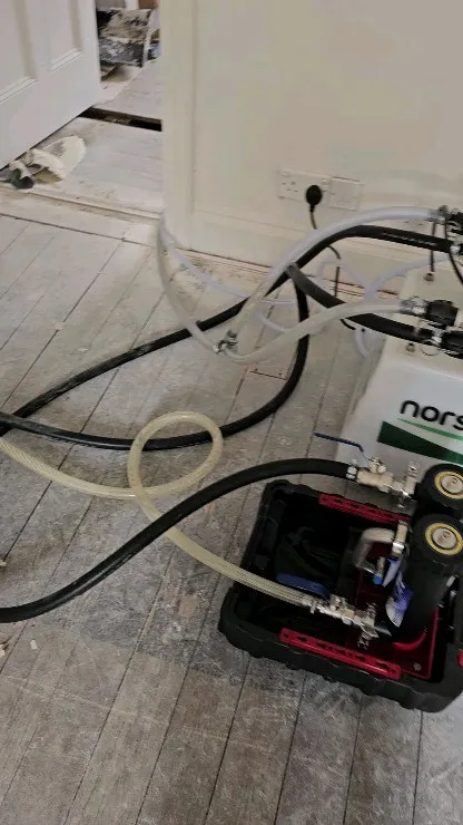 A floor cleaning machine on the floor of a house.
