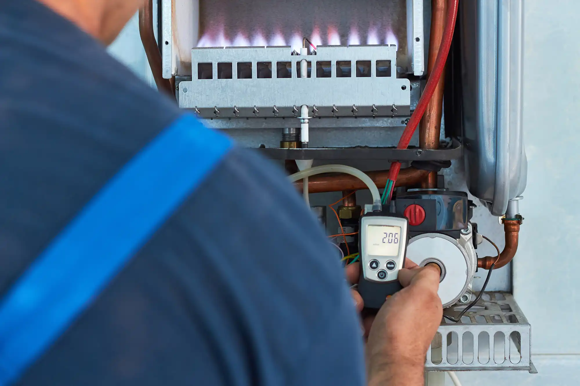 A man is working on an electrical device.