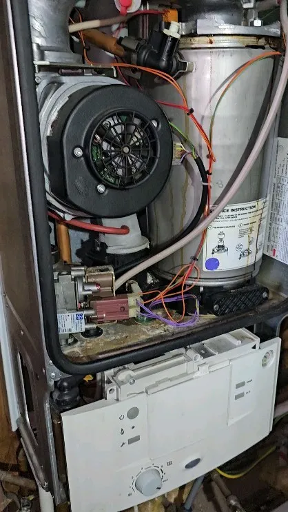 The inside of a furnace with wires and wires.