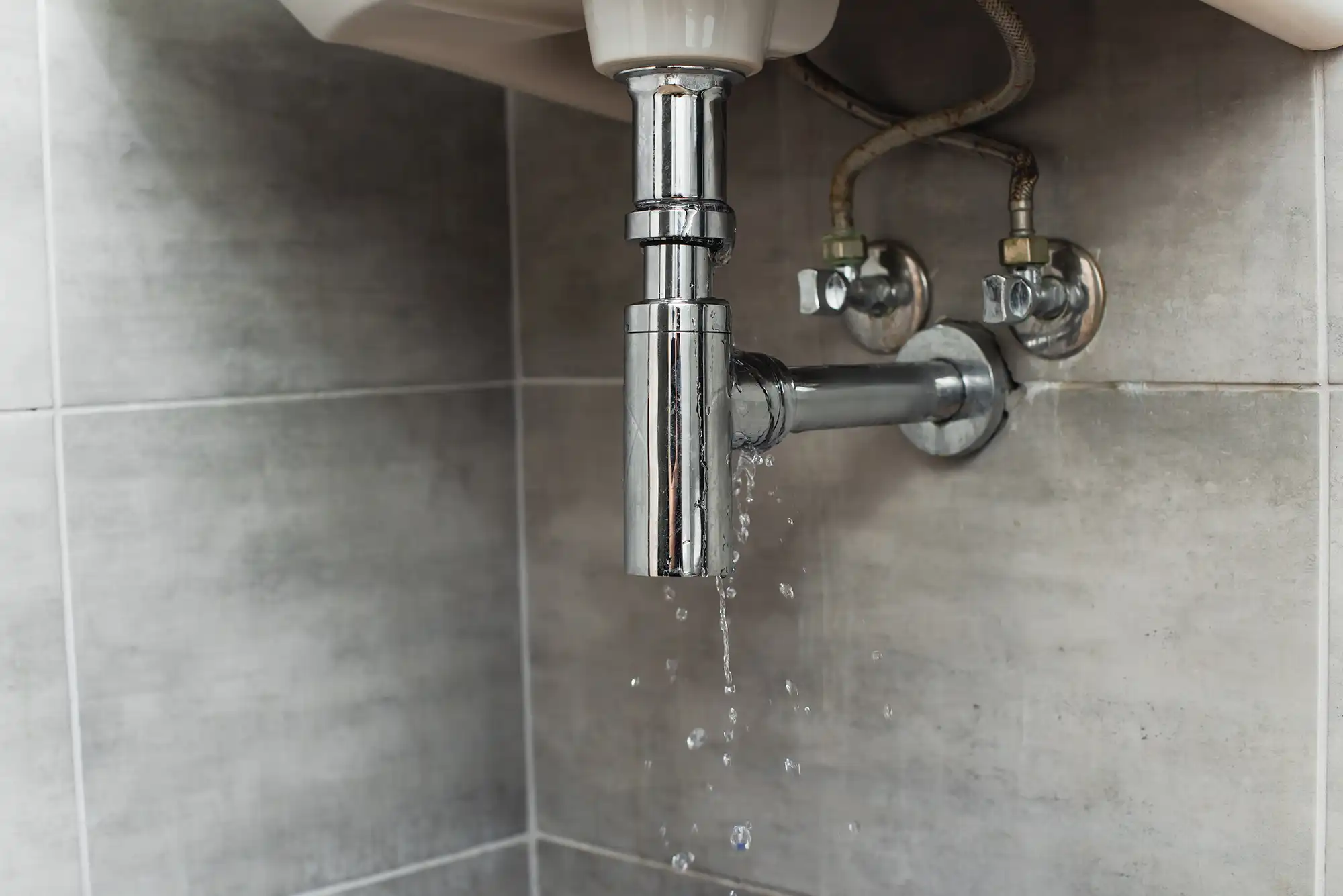 A tap that is connected to a sink in a bathroom.